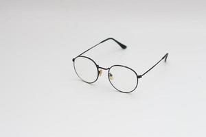 a close up of eyeglasses with black frames isolated on white background photo