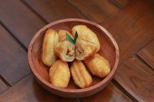 Comro or combro, a traditional Javanese snack made of deep fried grated cassava filled with a savory mix of oncom or fermented soy bean cake and chili photo