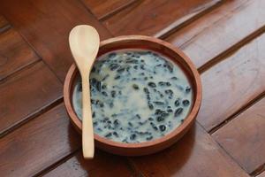 a close up of a bowl of traditional Indonesian drink called Dawet Ireng or black dawet. Indonesian traditional food photo concept.