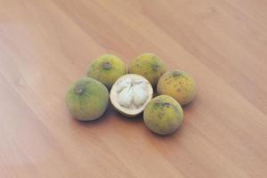 greenish yellow harp fruit isolated on money table has sweet and sour taste. Food concept photo. photo