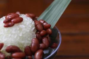 Es Kacang Merah or a cold drink made from red beans boiled with brown sugar served with coconut milk, shaved ice and covered with sweetened condensed milk chocolate and syrup. photo