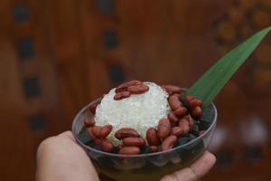 Es Kacang Merah or a cold drink made from red beans boiled with brown sugar served with coconut milk, shaved ice and covered with sweetened condensed milk chocolate and syrup. photo