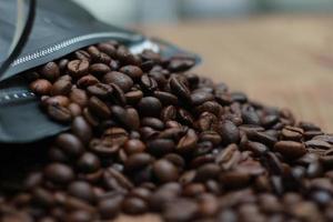 Detailed photo of coffee beans before being processed into a drink isolated on wood. Concept photo of the basic ingredients of coffee drinks.