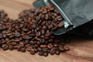 Detailed photo of coffee beans before being processed into a drink isolated on wood. Concept photo of the basic ingredients of coffee drinks.