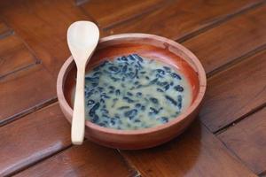 a close up of a bowl of traditional Indonesian drink called Dawet Ireng or black dawet. Indonesian traditional food photo concept.