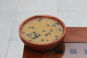 a close up of a bowl of traditional Indonesian drink called Dawet Ireng or black dawet. Indonesian traditional food photo concept.
