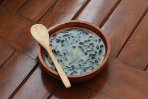 a close up of a bowl of traditional Indonesian drink called Dawet Ireng or black dawet. Indonesian traditional food photo concept.