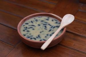 a close up of a bowl of traditional Indonesian drink called Dawet Ireng or black dawet. Indonesian traditional food photo concept.