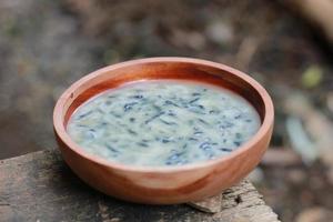 a close up of a bowl of traditional Indonesian drink called Dawet Ireng or black dawet. Indonesian traditional food photo concept.