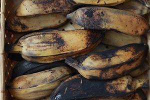 a close up of steamed bananas served on a woven bamboo container. photo