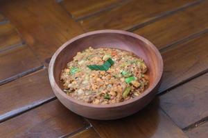 a close up Rujak Bebek or smashed fruit which is made from raw fruit crushed in a mortar and pestle and added with shrimp paste, chili and brown sugar. Indonesian traditional food photo concept.