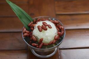 Es Kacang Merah or a cold drink made from red beans boiled with brown sugar served with coconut milk, shaved ice and covered with sweetened condensed milk chocolate and syrup. photo