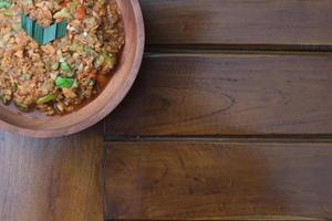 a close up Rujak Bebek or smashed fruit which is made from raw fruit crushed in a mortar and pestle and added with shrimp paste, chili and brown sugar. Indonesian traditional food photo concept.