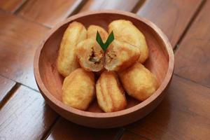 Comro or combro, a traditional Javanese snack made of deep fried grated cassava filled with a savory mix of oncom or fermented soy bean cake and chili photo