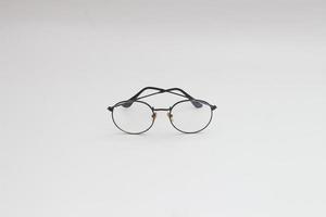 a close up of eyeglasses with black frames isolated on white background photo