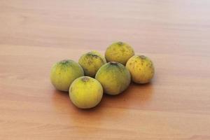 greenish yellow harp fruit isolated on money table has sweet and sour taste. Food concept photo. photo