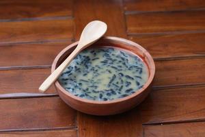 a close up of a bowl of traditional Indonesian drink called Dawet Ireng or black dawet. Indonesian traditional food photo concept.