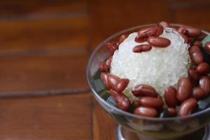 Es Kacang Merah or a cold drink made from red beans boiled with brown sugar served with coconut milk, shaved ice and covered with sweetened condensed milk chocolate and syrup. photo