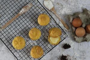 a traditional cake from Indonesia called kue sus filled with cream puffs. served on a cake rack. Food concept photo. photo