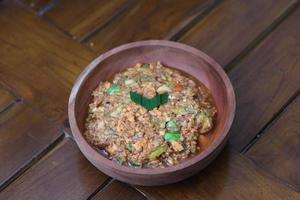 a close up Rujak Bebek or smashed fruit which is made from raw fruit crushed in a mortar and pestle and added with shrimp paste, chili and brown sugar. Indonesian traditional food photo concept.