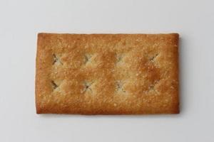 a close up of coconut biscuit with sprinkled sugar isolated on white background. photo