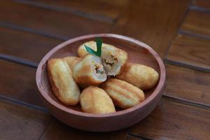 Comro or combro, a traditional Javanese snack made of deep fried grated cassava filled with a savory mix of oncom or fermented soy bean cake and chili photo