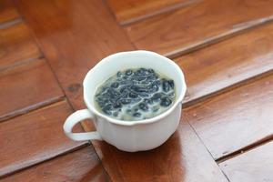 a close up of a glass of a traditional Indonesian drink called Dawet Ireng or black dawet. Indonesian traditional food photo concept.