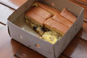 a dish called sweet martabak topped with raisins and bananas tastes sweet and is filling. made from flour dough. served warm. Food concept photo. photo