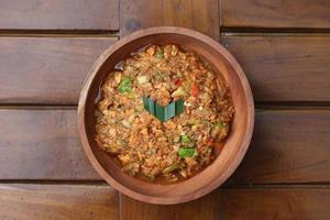 a close up Rujak Bebek or smashed fruit which is made from raw fruit crushed in a mortar and pestle and added with shrimp paste, chili and brown sugar. Indonesian traditional food photo concept.