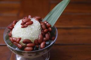 Es Kacang Merah or a cold drink made from red beans boiled with brown sugar served with coconut milk, shaved ice and covered with sweetened condensed milk chocolate and syrup. photo