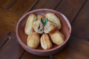 Comro or combro, a traditional Javanese snack made of deep fried grated cassava filled with a savory mix of oncom or fermented soy bean cake and chili photo