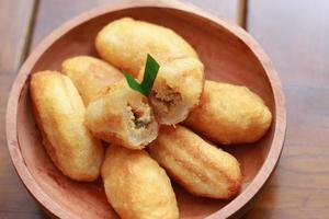 Comro or combro, a traditional Javanese snack made of deep fried grated cassava filled with a savory mix of oncom or fermented soy bean cake and chili photo