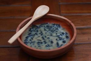 a close up of a bowl of traditional Indonesian drink called Dawet Ireng or black dawet. Indonesian traditional food photo concept.