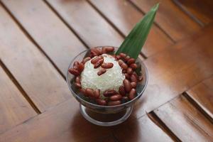 Es Kacang Merah or a cold drink made from red beans boiled with brown sugar served with coconut milk, shaved ice and covered with sweetened condensed milk chocolate and syrup. photo