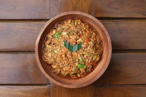 a close up Rujak Bebek or smashed fruit which is made from raw fruit crushed in a mortar and pestle and added with shrimp paste, chili and brown sugar. Indonesian traditional food photo concept.