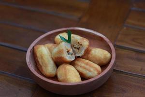 Comro or combro, a traditional Javanese snack made of deep fried grated cassava filled with a savory mix of oncom or fermented soy bean cake and chili photo