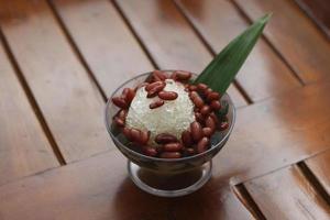 Es Kacang Merah or a cold drink made from red beans boiled with brown sugar served with coconut milk, shaved ice and covered with sweetened condensed milk chocolate and syrup. photo