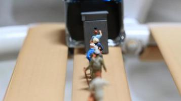 miniature figures of people queuing for public toilets. the concept of social etiquette. photo