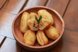Comro or combro, a traditional Javanese snack made of deep fried grated cassava filled with a savory mix of oncom or fermented soy bean cake and chili photo