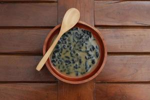 a close up of a bowl of traditional Indonesian drink called Dawet Ireng or black dawet. Indonesian traditional food photo concept.