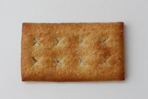 a close up of coconut biscuit with sprinkled sugar isolated on white background. photo