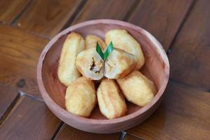 Comro or combro, a traditional Javanese snack made of deep fried grated cassava filled with a savory mix of oncom or fermented soy bean cake and chili photo
