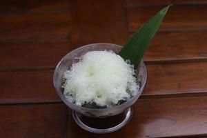 Es Kacang Merah or a cold drink made from red beans boiled with brown sugar served with coconut milk, shaved ice and covered with sweetened condensed milk chocolate and syrup. photo