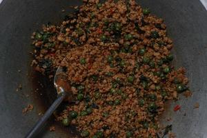 a close up of a side dish with stir-fried leunca and oncom photo