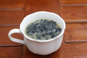 a close up of a glass of a traditional Indonesian drink called Dawet Ireng or black dawet. Indonesian traditional food photo concept.