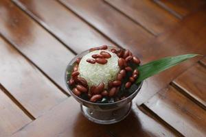 Es Kacang Merah or a cold drink made from red beans boiled with brown sugar served with coconut milk, shaved ice and covered with sweetened condensed milk chocolate and syrup. photo