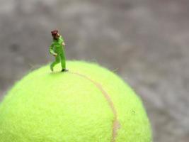 a close up of a miniature figure of a runner jogging on a baseball. sport photo concept.