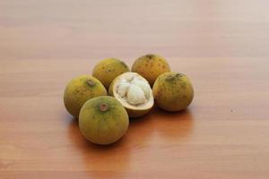 greenish yellow harp fruit isolated on money table has sweet and sour taste. Food concept photo. photo