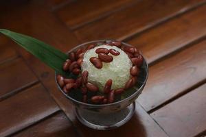Es Kacang Merah or a cold drink made from red beans boiled with brown sugar served with coconut milk, shaved ice and covered with sweetened condensed milk chocolate and syrup. photo