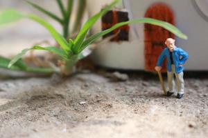 miniature figure of a grandfather who is waiting in front of the house. photo